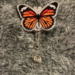 Butterfly Badge Reel with Orange and Black Design